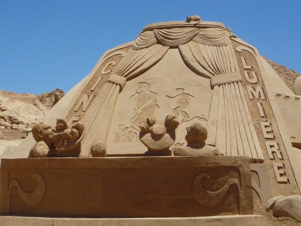 the poster realised as a sand sculpture